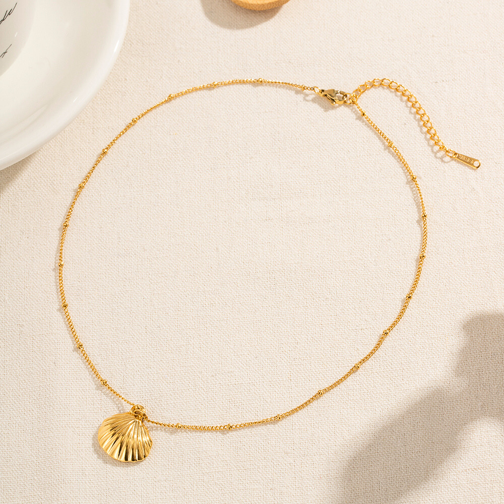 Sea Shell Gold Plated Pendant and chain on Table by The Happiness Store